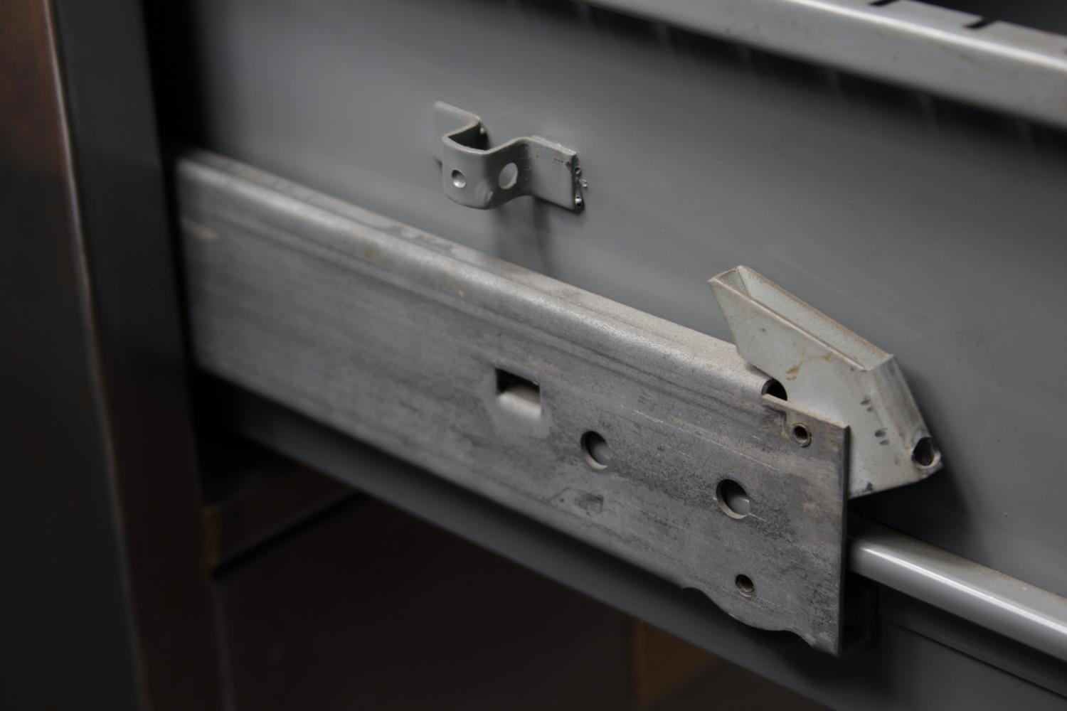 A vintage polished steel filing cabinet with twin brass handles and brass plate to each drawer. H. - Image 9 of 11