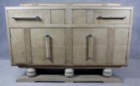 A mid century Art Deco style light oak sideboard. H.95 W.138 D.54cm