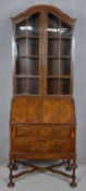 A mid century burr walnut William and Mary style bureau bookcase with glazed upper section above