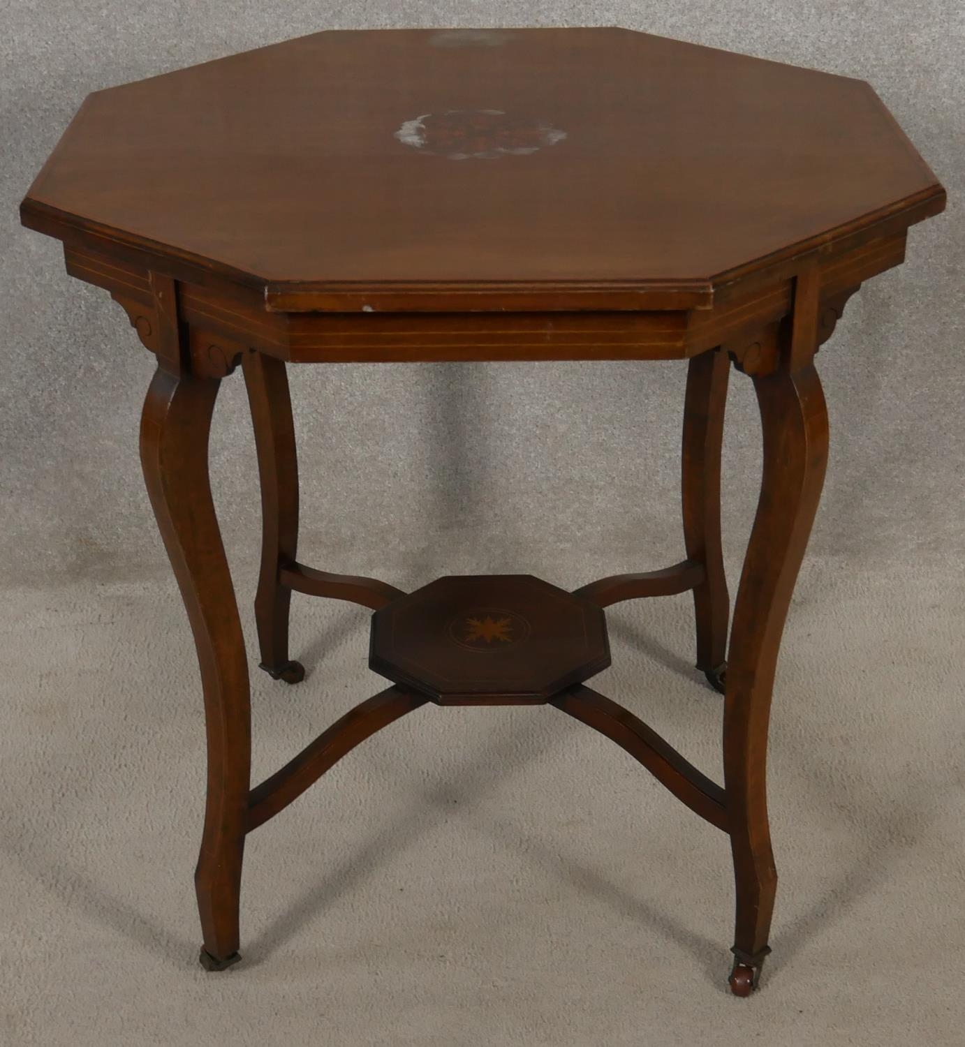 An Edwardian mahogany and satinwood strung occasional table with central floral inlay on cabriole