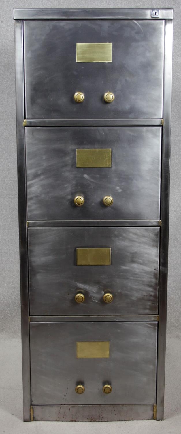 A vintage polished steel filing cabinet with twin brass handles and brass plate to each drawer. H.