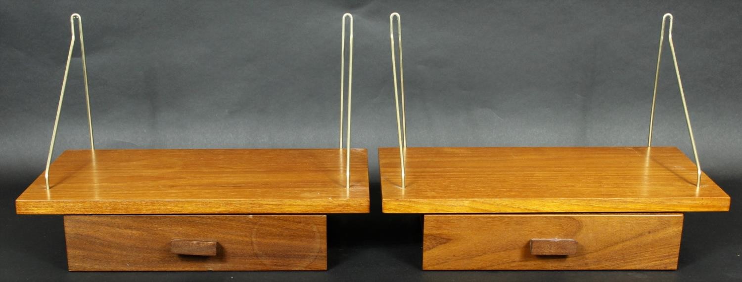 A pair of vintage teak hanging wall shelves fitted with frieze drawers. H.26 W.40 D.21cm