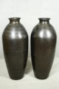 A pair of large contemporary floor standing hammered brass vases. H.79cm