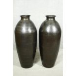 A pair of large contemporary floor standing hammered brass vases. H.79cm