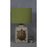 A Porto Romana ceramic lamp with transfer design of a tortoise and green silk shade. H.65