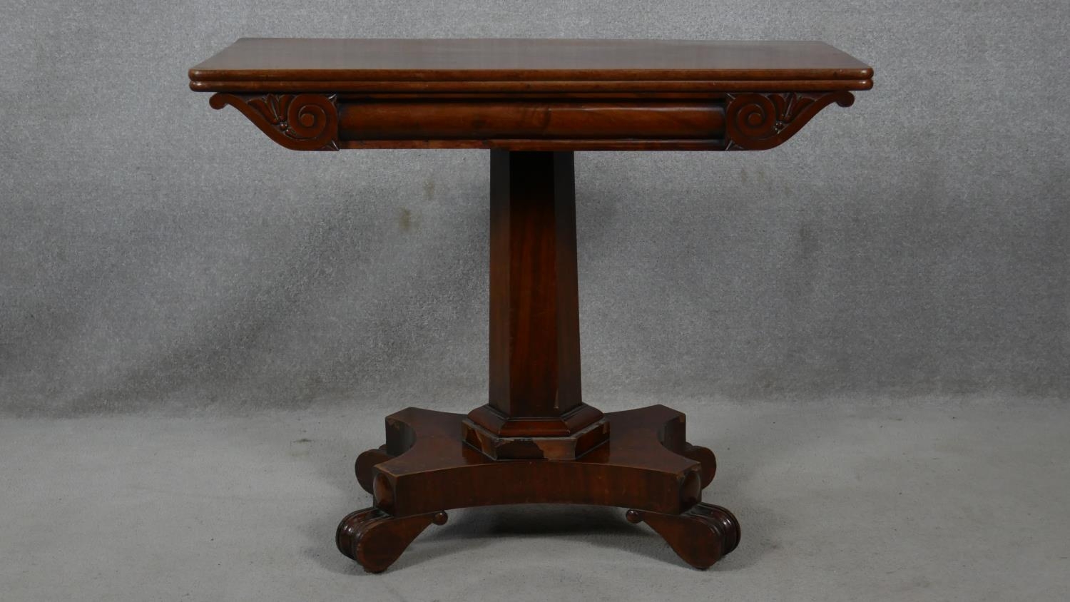 A William IV mahogany fold over top tea table on facetted pedestal quadruped base. H.72 L.48 W.92cm