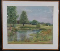 A framed and glazed pastel, pond in a landscape, indistinctly signed and dated. H.61 W.71cm