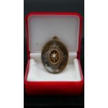 A Victorian yellow metal and pearl filigree detailed brooch/pendant. With secure hinged pin to the