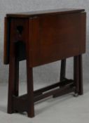 A late 19th century Art and Crafts walnut drop flap Sutherland table. H.57 L.69 W.64cm