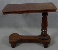 A William IV mahogany bed table with rise and fall action and a pair of adjustable reading slopes
