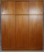 A 1960's vintage teak triple section wardrobe with revolving mirror to central panel. H.229 W.189