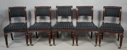 A set of five mid 19th century mahogany dining chairs in striped and studded upholstery on