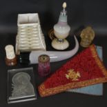 A collection of decorative items. Including a blown glass horn, a gold thread embroidered altar