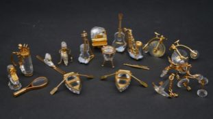 A collection of eighteen Swarovski crystal memories with gilt mounts; a pair of rowing boats with