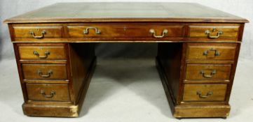 A C.1900 mahogany three section partner's pedestal desk with inset tooled leather top above an