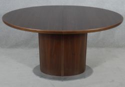 A Skovby of Denmark extending pedestal dining table with folding pop-up patent action central