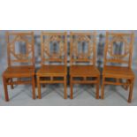 A set of four Chinese influenced hardwood dining chairs with panel seats on square section supports.