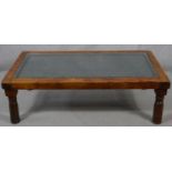 An Indian hardwood coffee table with plate glass on a metal lattice work inset top. H.41 L.132 W.