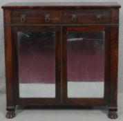A Regency rosewood chiffonier with lion's mask handles and mirrored doors with original plates