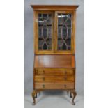 An early 20th century mahogany two section Georgian style bureau bookcase with fitted interior on