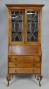 An early 20th century mahogany two section Georgian style bureau bookcase with fitted interior on