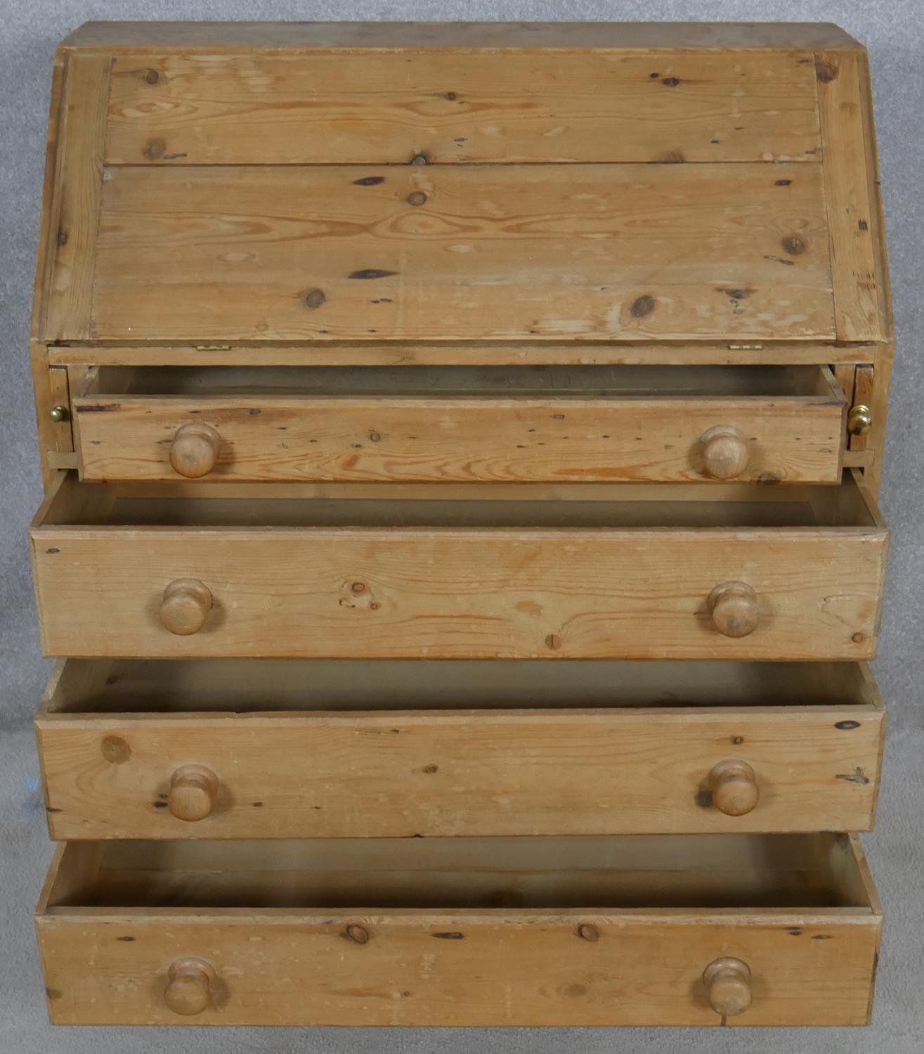 A 19th century pine bureau with fall front revealing a fitted interior above four long graduated - Image 2 of 4