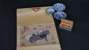 A Chinese embroidered scroll, three items of hand painted blue and white ceramics and a cased carved