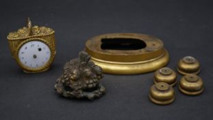 A French gilt metal grape basket clock and other clock mount pieces. The clock has white enamel dial