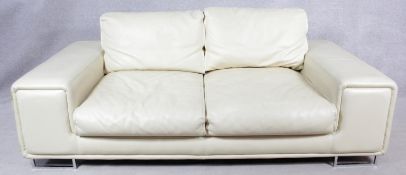 A contemporary two seater sofa in ivory leather upholstery on chrome supports. H.80 W.204 D.104cm