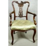 A C.1900 mahogany armchair with asymmetric Rococo carved back rail above stuff over seat on cabriole