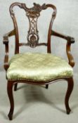 A C.1900 mahogany armchair with asymmetric Rococo carved back rail above stuff over seat on cabriole