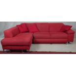 A ROM corner sofa with adjustable back cushions, converting to a double bed, on chrome supports. H.