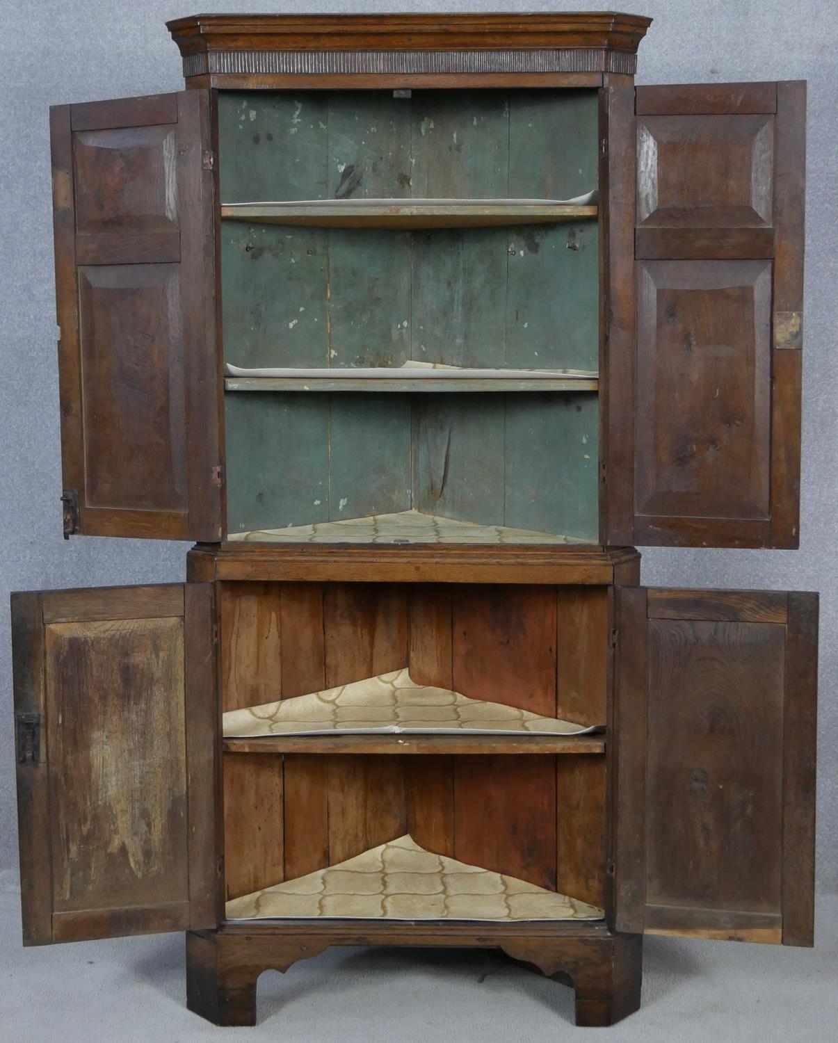 A Georgian oak two section corner cupboard with panel doors enclosing shelves on shaped bracket - Image 2 of 4