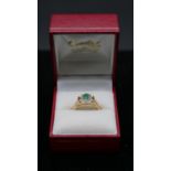 A 15 carat yellow gold emerald and diamond cluster ring. Set to centre with an oval mixed cut