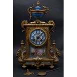 An early 20th century French gilt metal and porcelain mantel clock with eight day movement and