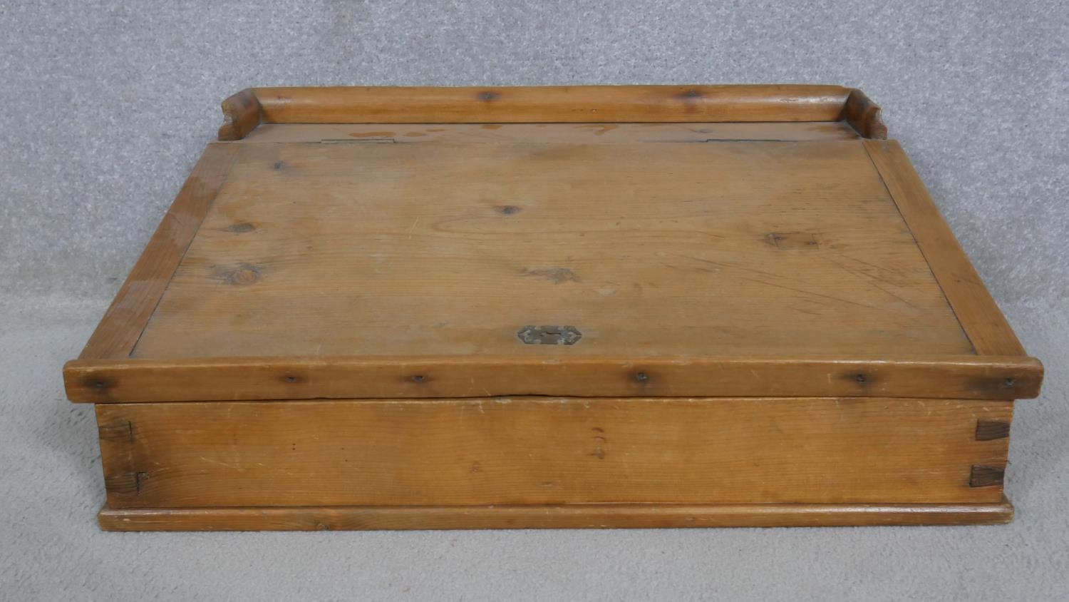 A pine clerk's writing slope with galleried top and hinged lid enclosing storage compartment. H.23