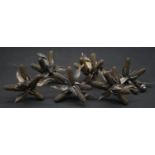 A set of six cast metal furniture handles in the form of corn ears.