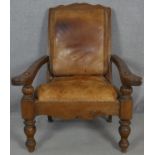 A 19th century teak planter's style armchair with folding leg rests in leather upholstery on