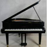 A Yamaha G1 grand piano in black gloss lacquered case on brass roller castors, serial number 2083203