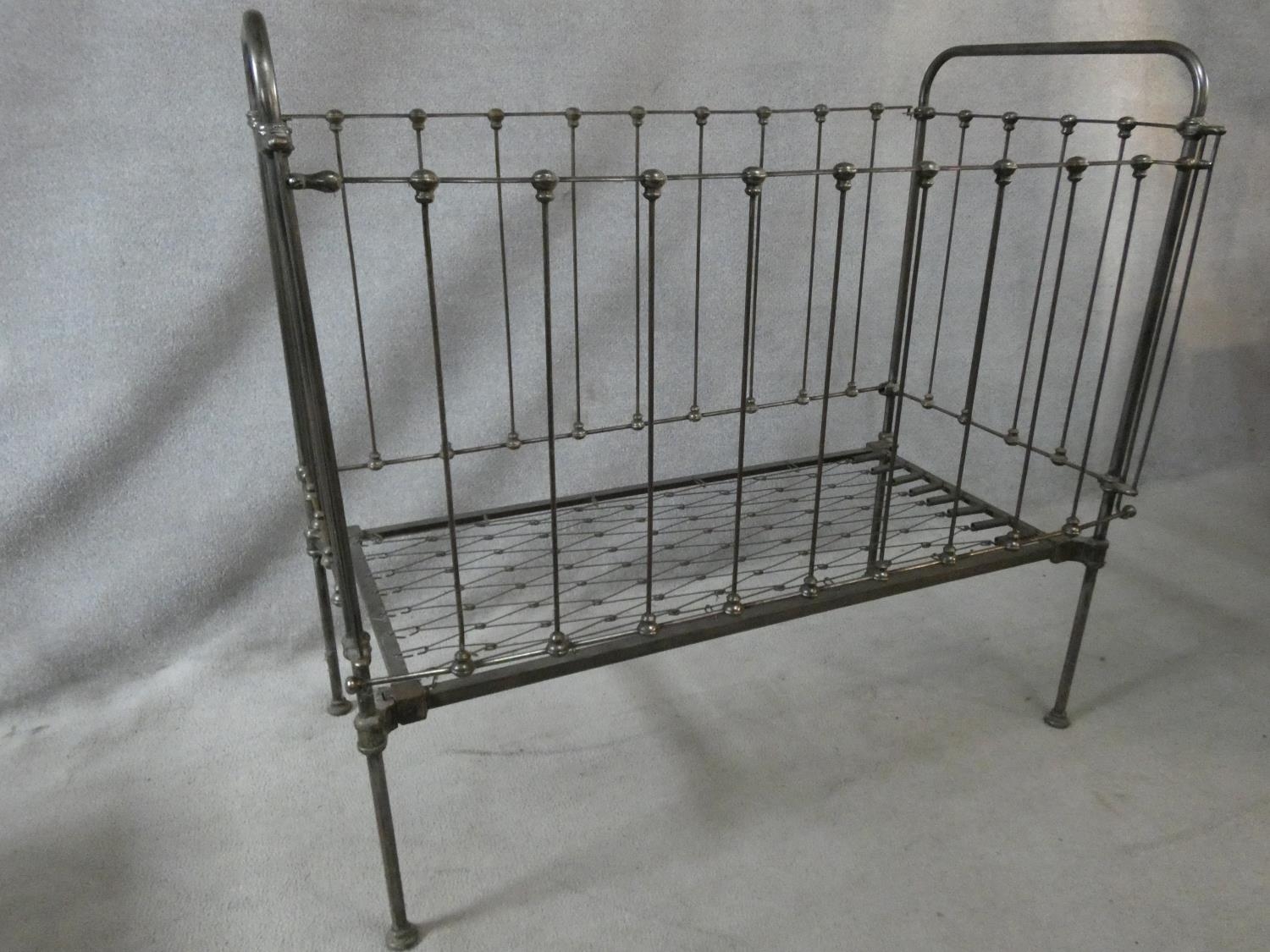 A Victorian wrought iron child's cot with fall front panel. H.114 L.124 W.63cm - Image 2 of 5