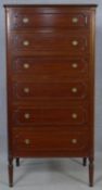 A Continental style mahogany tall chest of six drawers on shaped tapering supports. H.140.5 W.70.5