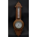 A late Victorian carved light oak banjo barometer thermometer. H.53.5 W.16.5cm