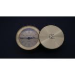 A Tiffany & Co. miniature portable alarm clock with Merrill Lynch logo to the sliding case cover,