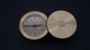 A Tiffany & Co. miniature portable alarm clock with Merrill Lynch logo to the sliding case cover,