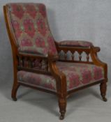 A late 19th century oak armchair upholstered in Liberty fabric raised on reeded turned supports. H.