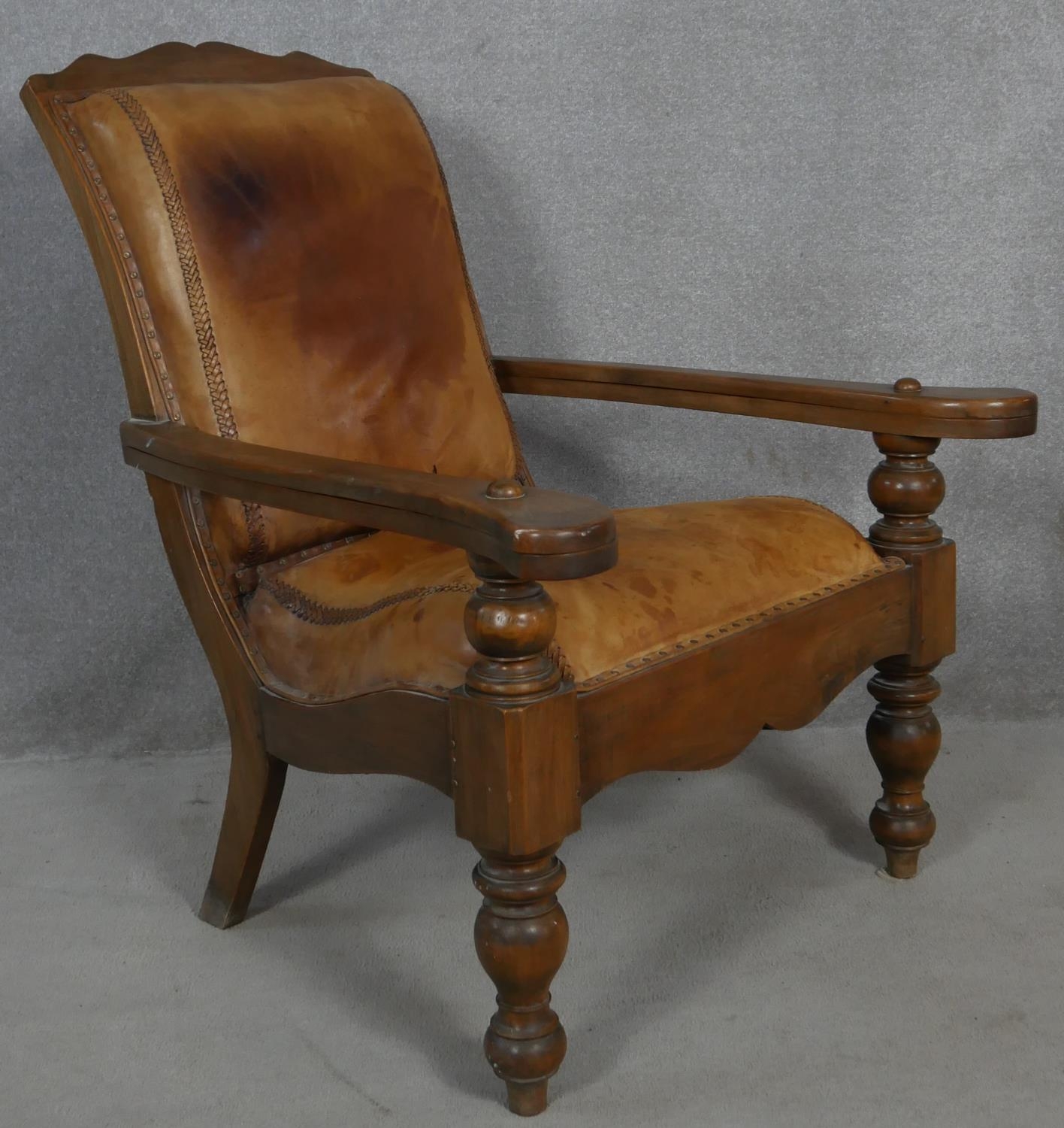 A 19th century teak planter's style armchair with folding leg rests in leather upholstery on - Image 2 of 8