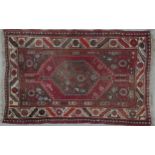 A Heriz rug with double pole central medallions in a stylised multi border. L.148 W.104cm