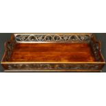 An Eastern hardwood twin handled tray with carved and pierced floral gallery. L.70 W.46cm