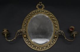 A late 19th century gilt metal twin branch girandole with bevelled plate in pierced floral frame.