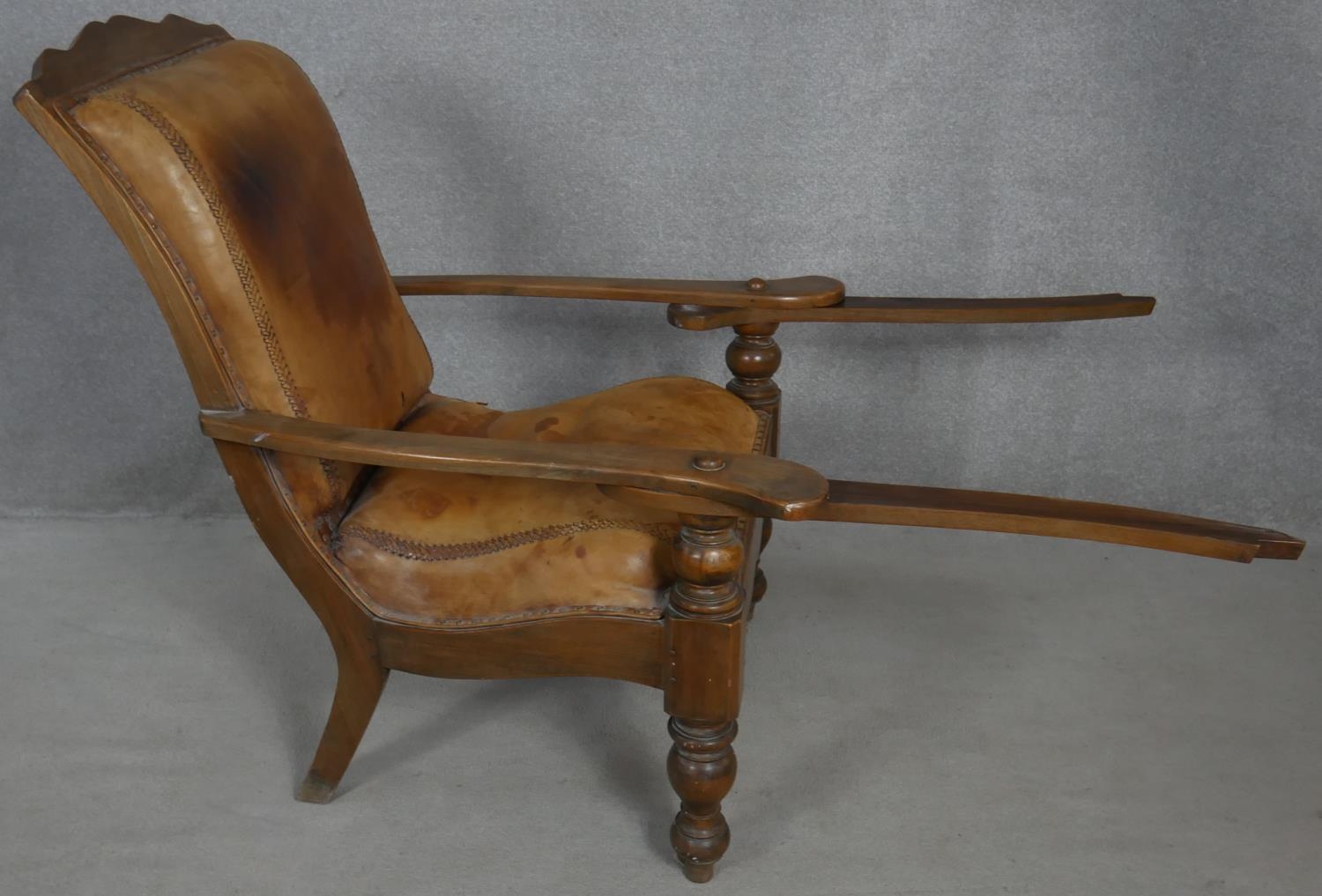 A 19th century teak planter's style armchair with folding leg rests in leather upholstery on - Image 3 of 8
